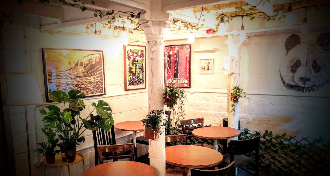Some of our art by Dran, Bast, Shepard Fairey and Ardif at the Long and Short cafe in Brick Lane